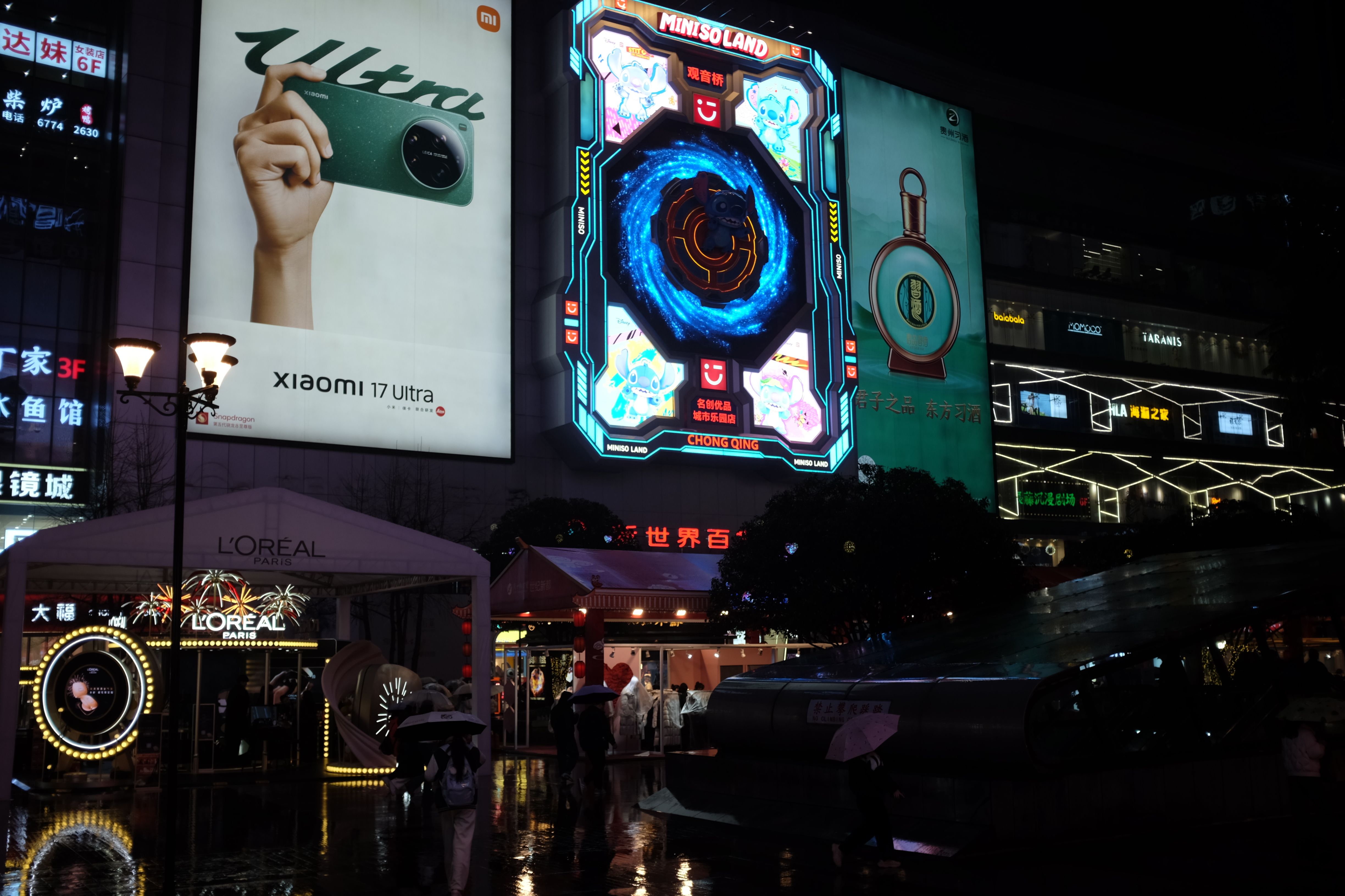Illuminated neon billboards in a city at night, evoking bold visual branding and digital advertising design.